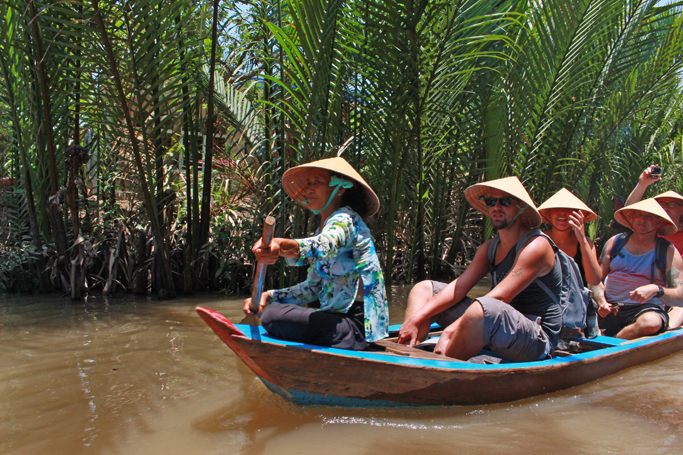 tourists mekong delta river vietnam boat ride