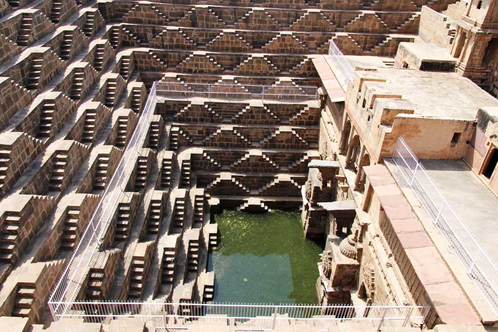 chand-baori-ancient-rajasthan-anciel-well-stepwell-ancient-india-jaipur-rajasthan-people-face-of-indian-batman-film-location-hindu-carving